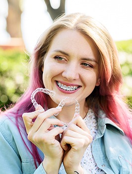 Girl With Braces Her Teeth Holds Aligners Image
